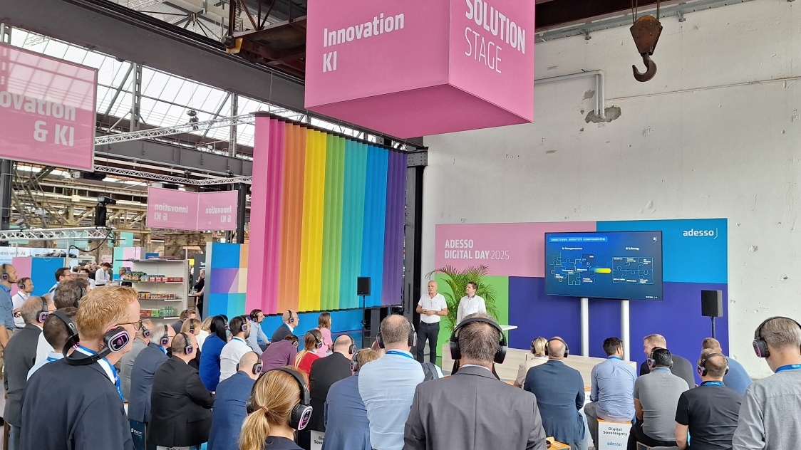 Publikum mit Kopfhörern beim Vortrag über KI-Prozessautomatisierung bei Adesso Digital Day
